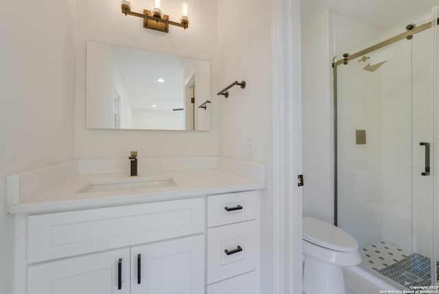 bathroom with vanity, an enclosed shower, and toilet