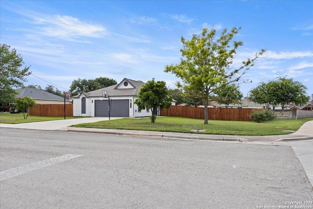 view of front of property featuring a front yard and a garage