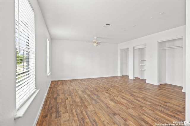 interior space with hardwood / wood-style floors, ceiling fan, and built in shelves