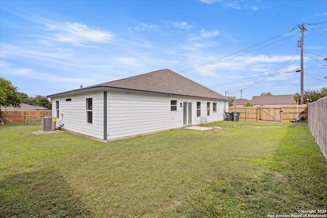 back of house featuring a yard and central air condition unit