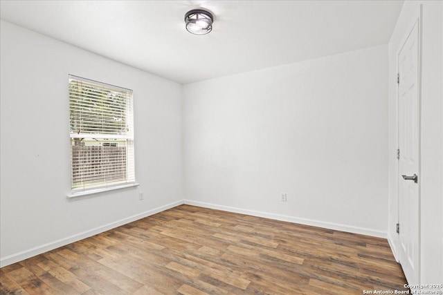 spare room with hardwood / wood-style floors