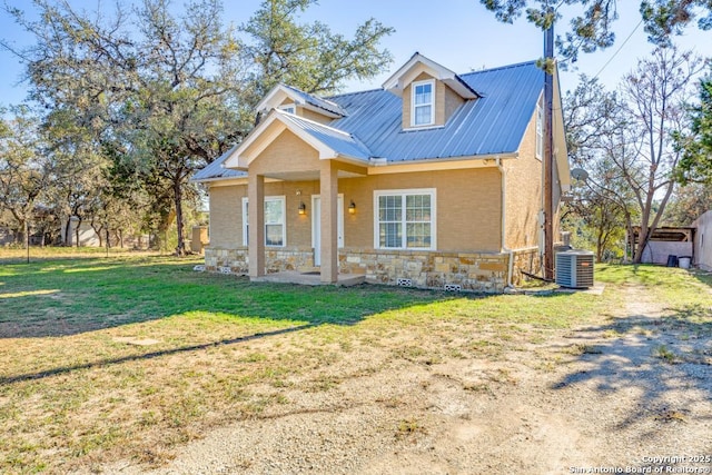 view of front of property featuring a front lawn and central AC unit