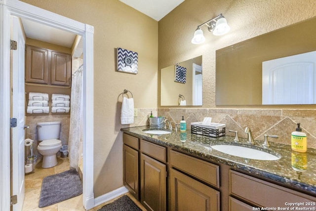 bathroom with tile patterned floors, vanity, and toilet