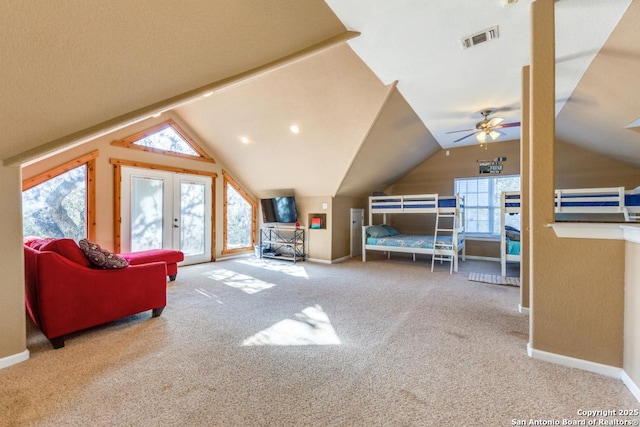 carpeted bedroom with lofted ceiling and french doors