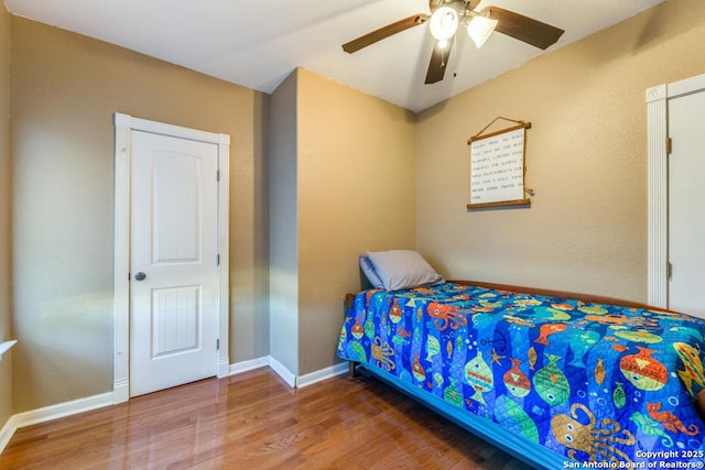 bedroom with ceiling fan and hardwood / wood-style flooring