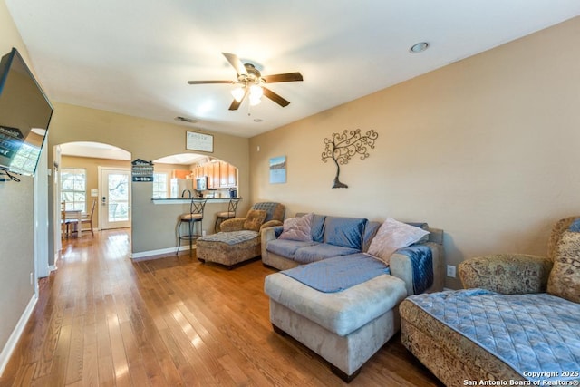 living room featuring hardwood / wood-style floors and ceiling fan