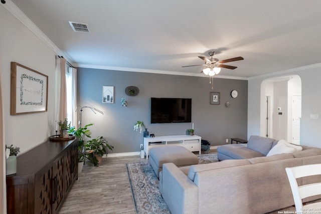 living room with crown molding, ceiling fan, and light hardwood / wood-style floors