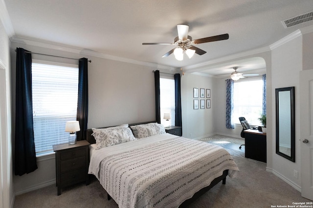 carpeted bedroom featuring ornamental molding and ceiling fan