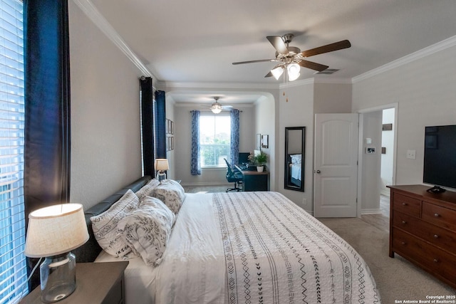 bedroom with light carpet, crown molding, and ceiling fan