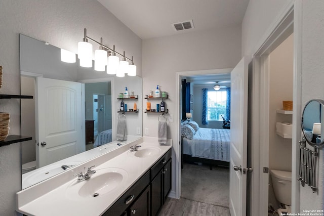 bathroom with wood-type flooring, toilet, and vanity