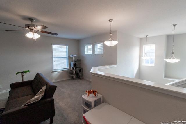 carpeted living room featuring ceiling fan