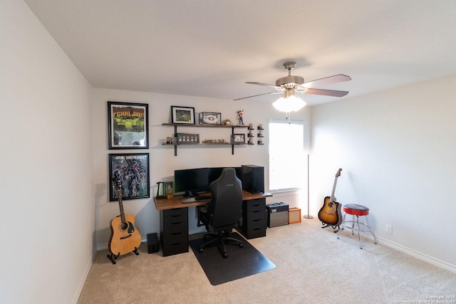 carpeted office space featuring ceiling fan