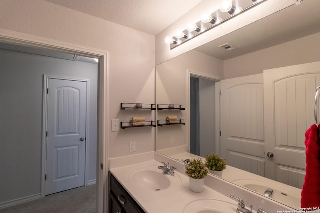 bathroom featuring vanity and a textured ceiling