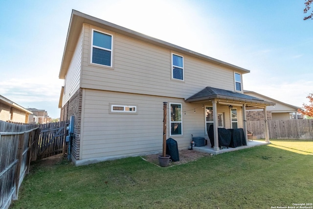 rear view of property featuring a yard, a patio area, ceiling fan, and central air condition unit