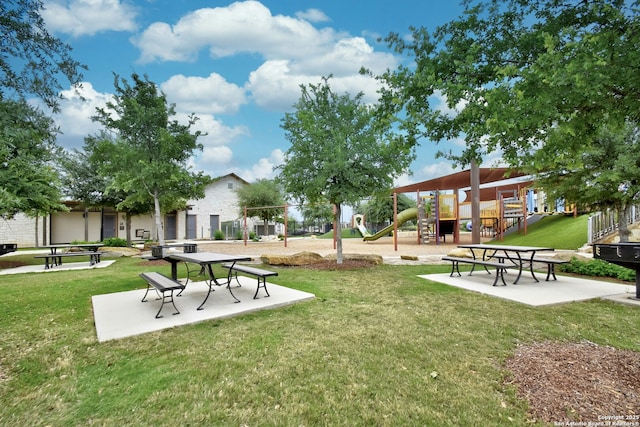 view of community featuring a playground and a yard