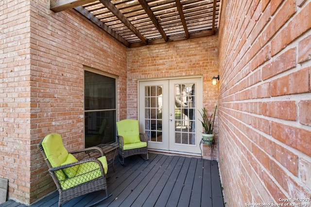 wooden terrace featuring a pergola and french doors