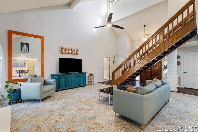 living room with ceiling fan and high vaulted ceiling