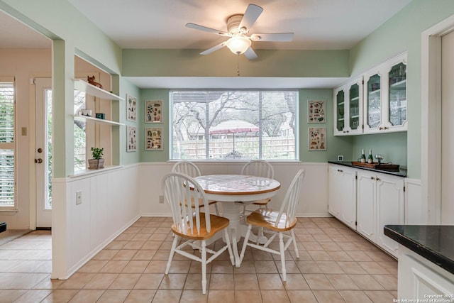 dining room featuring ceiling fan, light tile patterned floors, and a healthy amount of sunlight