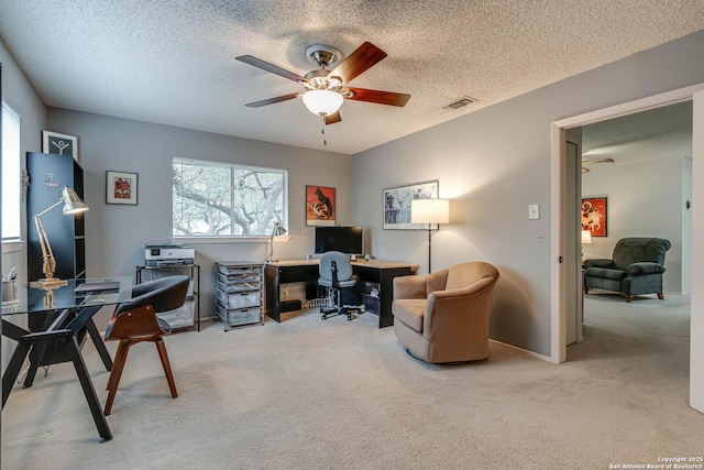 carpeted office with ceiling fan and a textured ceiling