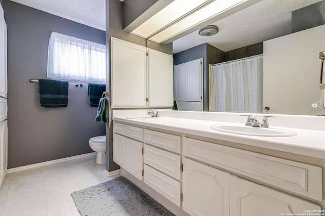 bathroom with a textured ceiling, toilet, and vanity