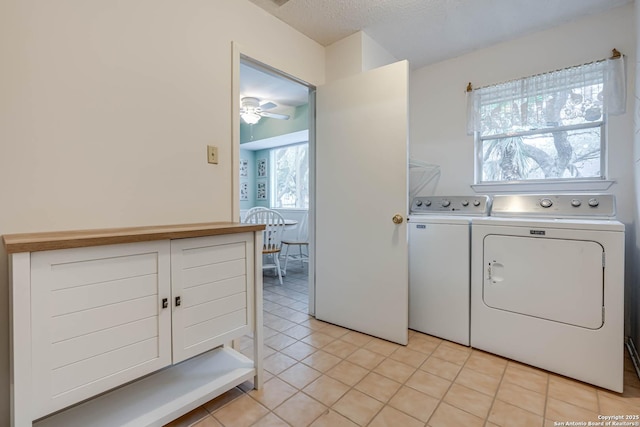 laundry room featuring ceiling fan, light tile patterned floors, washing machine and clothes dryer, and a textured ceiling