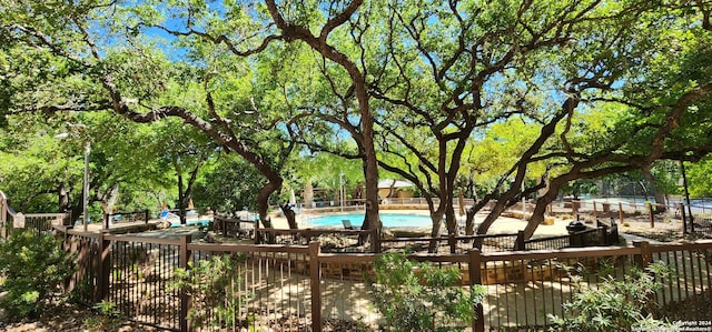 view of property's community featuring a trampoline and a swimming pool