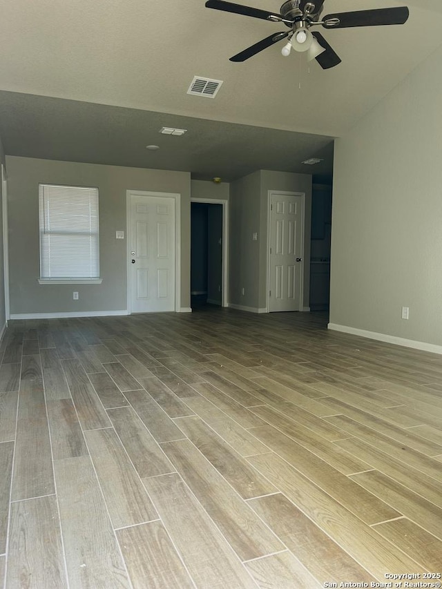 unfurnished living room with ceiling fan and light hardwood / wood-style flooring