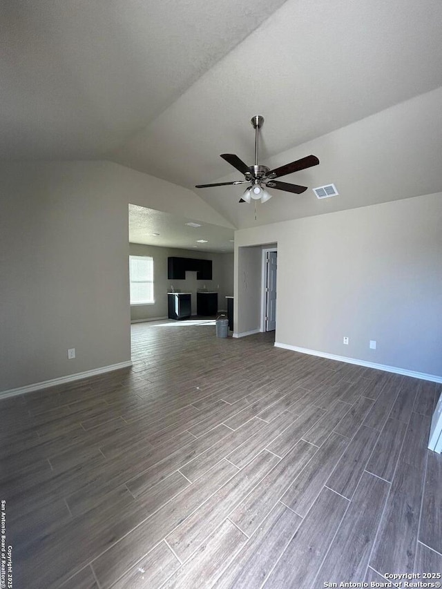 unfurnished living room featuring ceiling fan and lofted ceiling