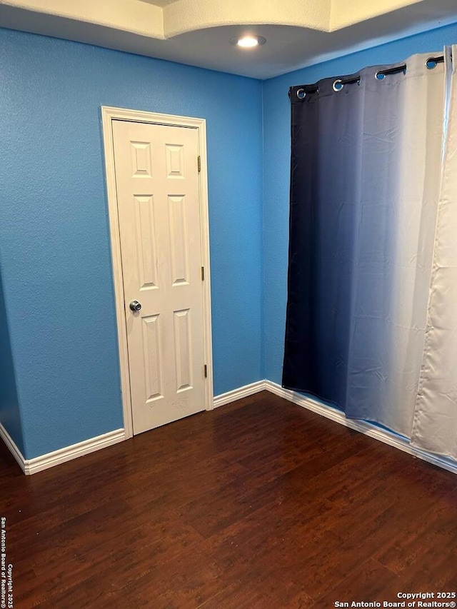 empty room featuring dark hardwood / wood-style floors