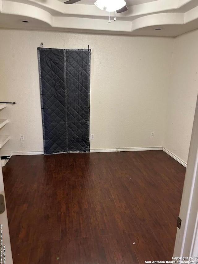 empty room with dark hardwood / wood-style flooring