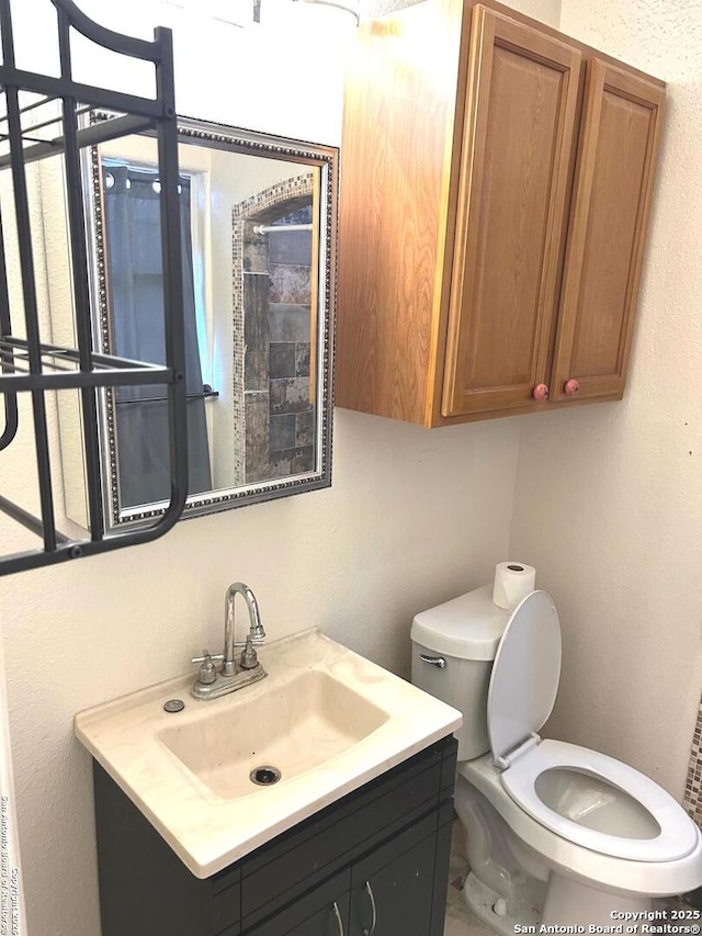 bathroom featuring vanity and toilet