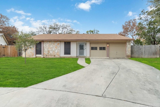 ranch-style home featuring a garage and a front lawn