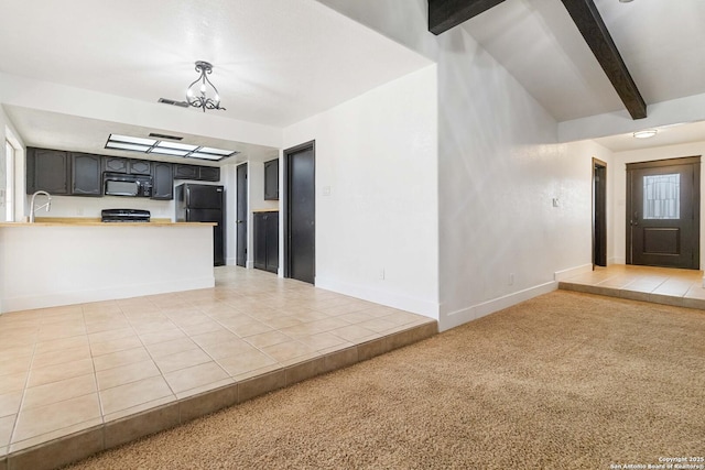 interior space featuring a chandelier, black appliances, light colored carpet, kitchen peninsula, and beamed ceiling