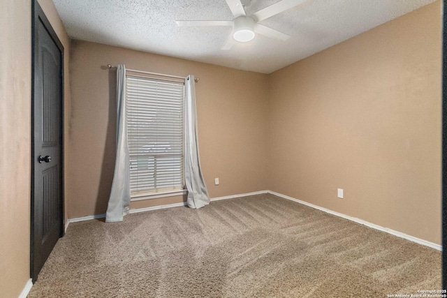 carpeted spare room with ceiling fan and a textured ceiling