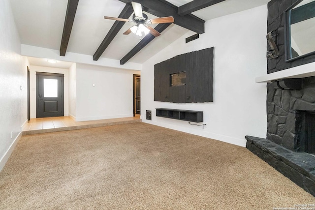 living room with a stone fireplace, carpet floors, lofted ceiling with beams, and ceiling fan