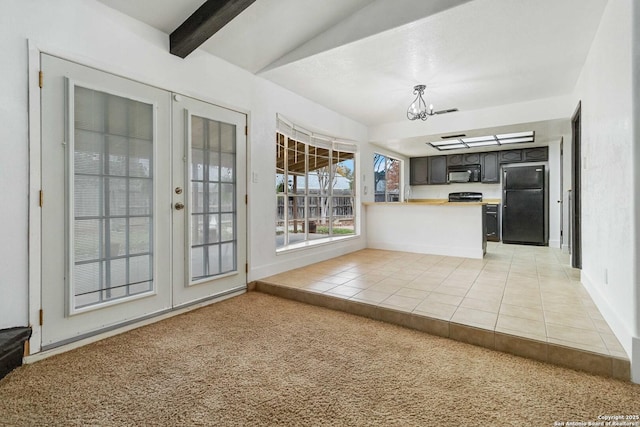 kitchen with french doors, a chandelier, refrigerator, dark brown cabinets, and light carpet