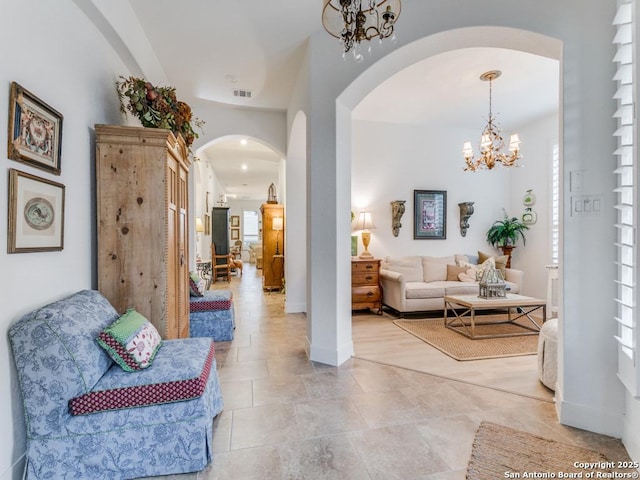 hallway featuring an inviting chandelier