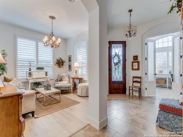 entrance foyer featuring a healthy amount of sunlight and a chandelier