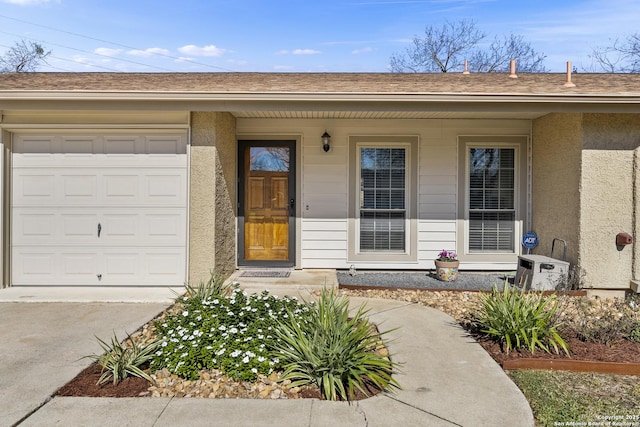 doorway to property with a garage