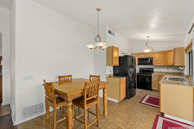 dining space featuring sink, light tile patterned floors, and vaulted ceiling