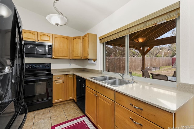 kitchen featuring black appliances, sink, vaulted ceiling, light tile patterned floors, and light stone counters