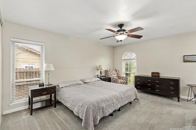 bedroom with ceiling fan and light carpet