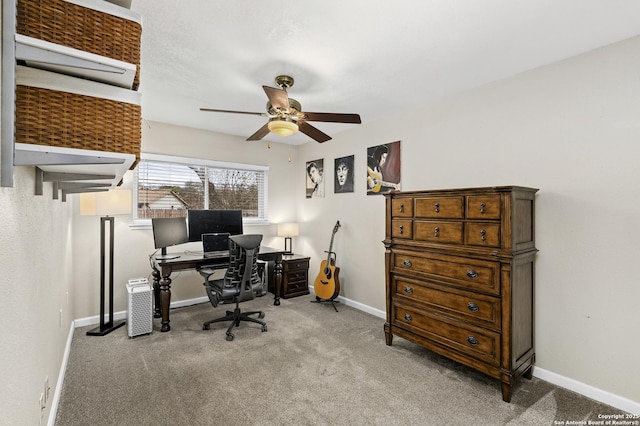 carpeted home office featuring ceiling fan