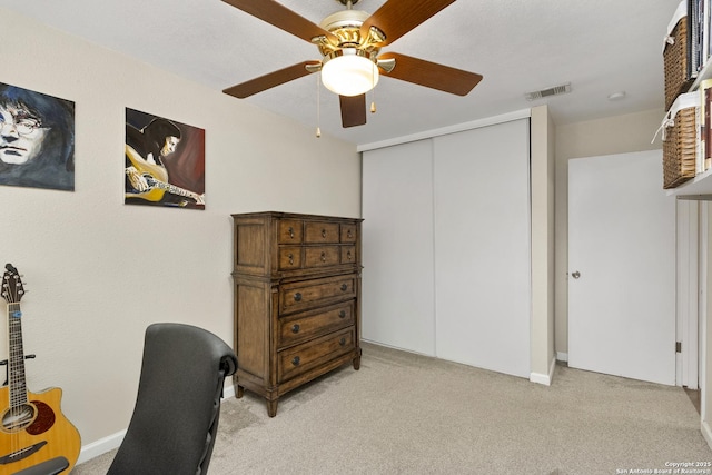 office space featuring ceiling fan and light colored carpet