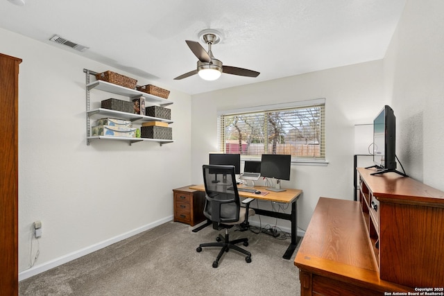 carpeted home office with ceiling fan