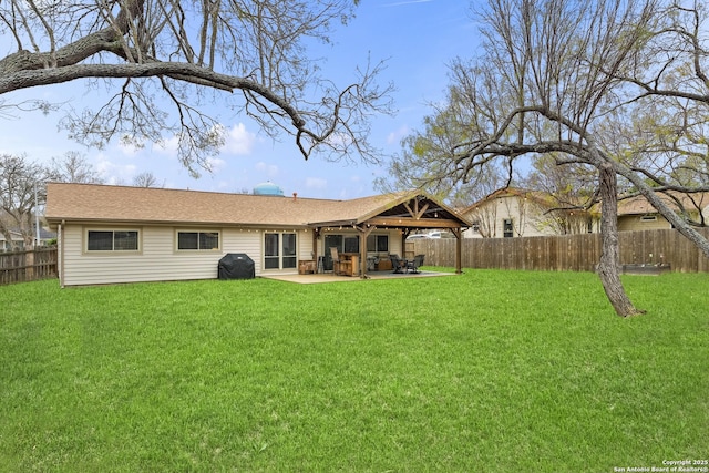 rear view of property with a lawn and a patio