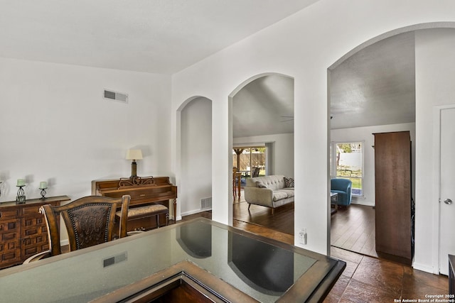 kitchen featuring vaulted ceiling and dark tile patterned floors