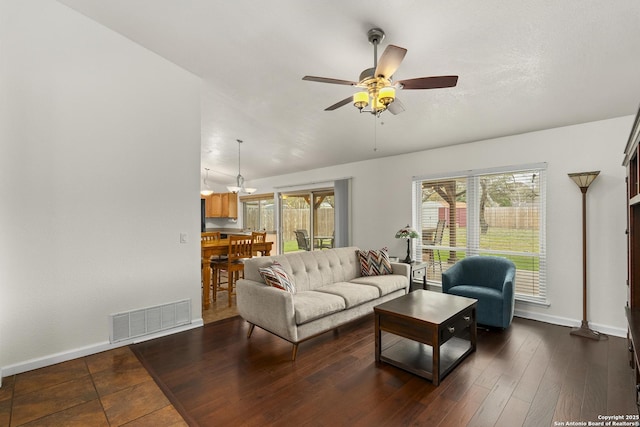 living room with ceiling fan and dark wood-type flooring