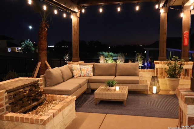 patio at twilight featuring an outdoor living space