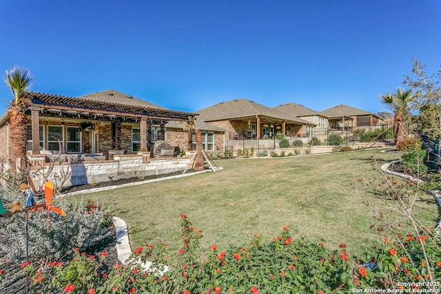 rear view of house featuring a patio area and a yard